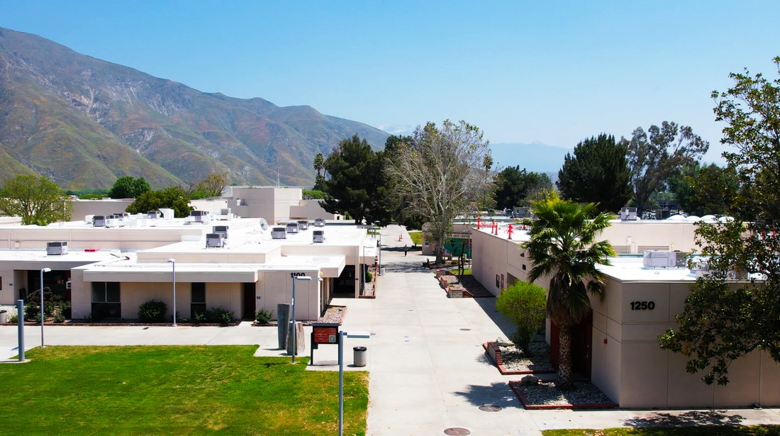 Aerial view of homes with hills in the background