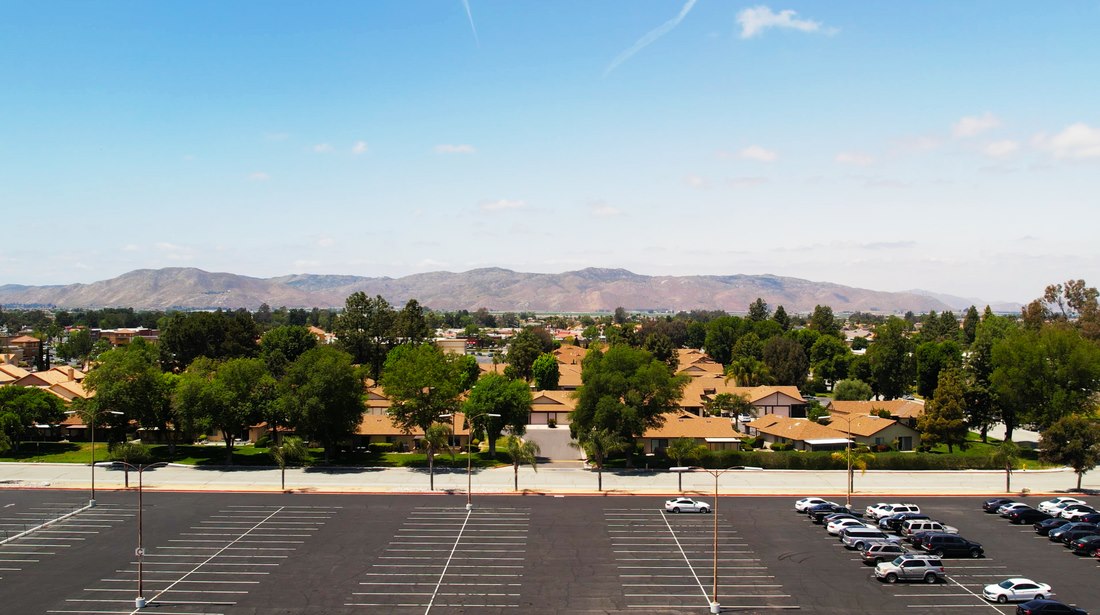 Aerial view of a parking area and nearby facilities