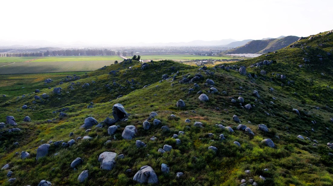 Aerial landscape with hills and a field